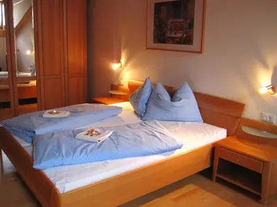 a bedroom with two beds with blue pillows at Stofflhof in Proves