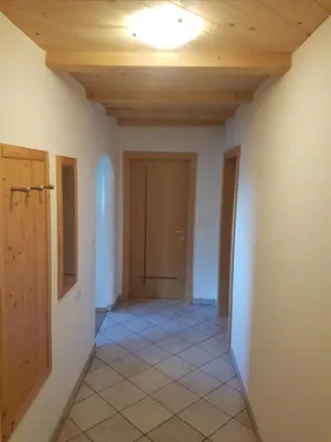 an empty hallway with a door and a ceiling at Stofflhof in Proves