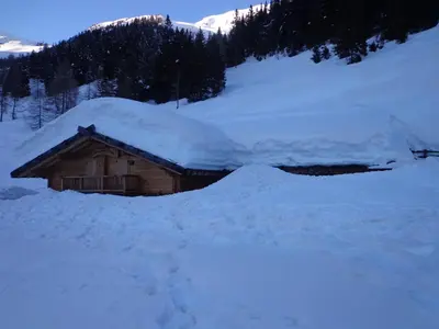 a small building covered in snow on a mountain at Stofflhof in Proves