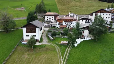 a group of houses on a green field at Stofflhof in Proves