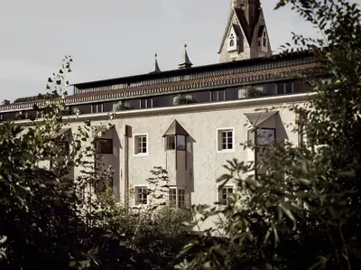 a large building with a tower on top of it at ADLER Historic Guesthouse in Bressanone
