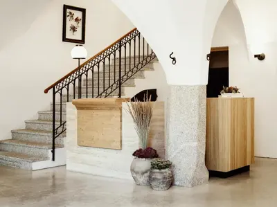 a staircase in a house with two vases at ADLER Historic Guesthouse in Bressanone