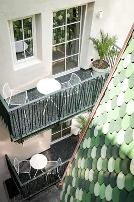 an overhead view of a balcony with tables and chairs at ADLER Historic Guesthouse in Bressanone