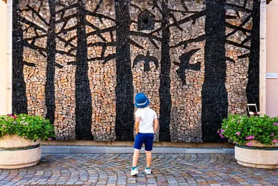 a young boy standing in front of a wall at Casa Lucia in Mezzano