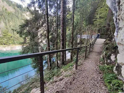 a path next to a river next to a fence at Casa Lucia in Mezzano
