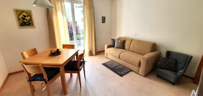 a living room with a table and a couch at Zweizimmer-Wohnung mit Parkgarage in Naturno