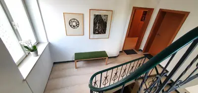 a staircase with a green chair in a room at Zweizimmer-Wohnung mit Parkgarage in Naturno