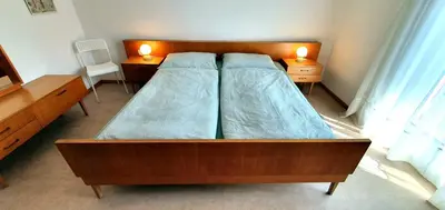 a bedroom with two beds and two lamps on tables at Zweizimmer-Wohnung mit Parkgarage in Naturno