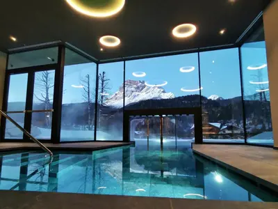 a bedroom with a large bed with red pillows at Parkhotel Ladinia in San Vito di Cadore