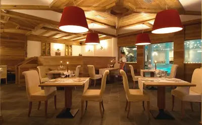 a large swimming pool in a building with lights at Parkhotel Ladinia in San Vito di Cadore
