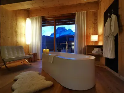 a restaurant with tables and chairs and red lights at Parkhotel Ladinia in San Vito di Cadore