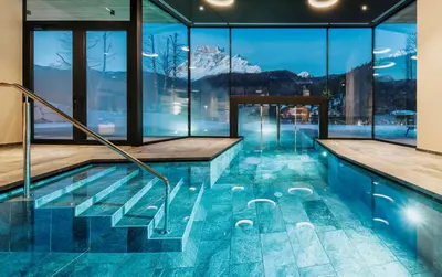 a bedroom with a bed and a view of a mountain at Parkhotel Ladinia in San Vito di Cadore