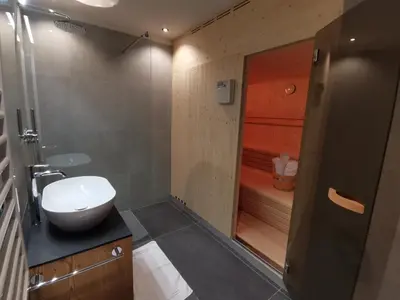 a bathroom with a sink and a shower with a toilet at Residence Maximilian in Valdaora
