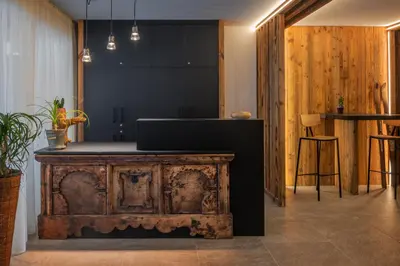 a kitchen with a wooden table and a counter top at Residence Maximilian in Valdaora