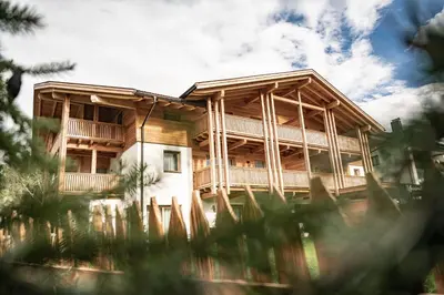 a log home with a wrap around porch at Residence Maximilian in Valdaora