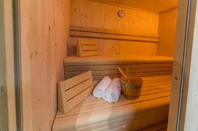a sauna with two towels and a bucket at Residence Maximilian in Valdaora