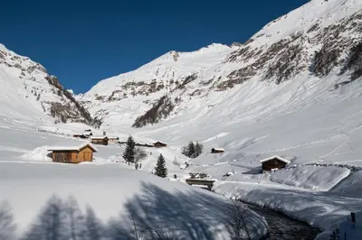 a snow covered mountain with houses in the distance at Appartamento Romantico a Valles in Valles
