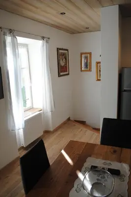 a living room with a table and a window at Casa Vacanza San Martino in Fondo
