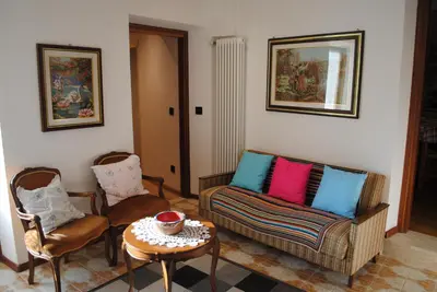 a living room with two chairs and a couch and a table at Casa Vacanza San Martino in Fondo