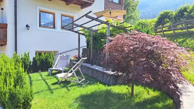 a couple of chairs sitting in the yard of a house at Pliegermoar - Adults Only in Vols am Schlern