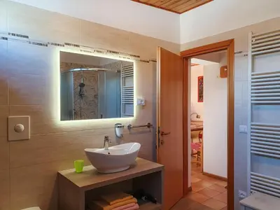 a bathroom with a sink and a mirror at Piccola Suite sul Civetta in Colle Santa Lucia
