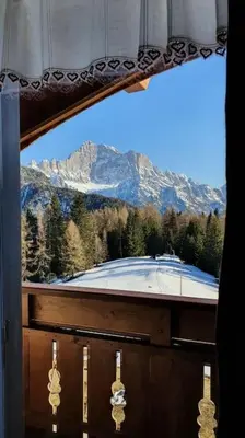 a window with a view of a snow covered mountain at Piccola Suite sul Civetta in Colle Santa Lucia