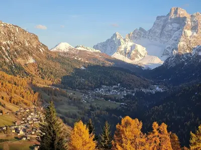 a town in the middle of a valley with mountains at Piccola Suite sul Civetta in Colle Santa Lucia