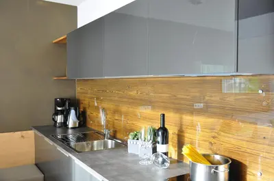 a kitchen with a dining table and a counter at Landhaus Freiburgerhof in Rifiano