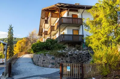 a building with a fence in front of it at Apartment Bellevue Seis in Siusi