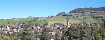 a small town on a hill with green hills at Apartment Bellevue Seis in Siusi