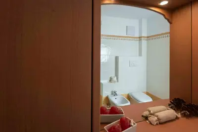 a bathroom with a sink and a counter with fruit on it at Casa Rododendro - Cavalese Dolomites in Cavalese