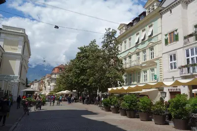 a city street with buildings and people on bikes at Hager Apartment 3 in Merano