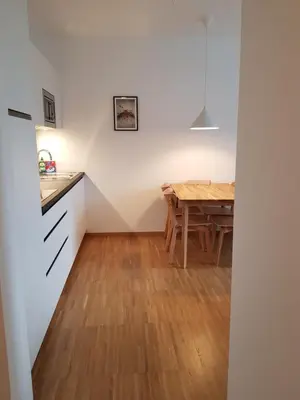 a kitchen and dining room with a wooden table at Hager Apartment 3 in Merano