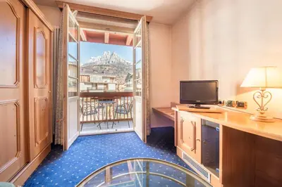 a hotel room with a view of a balcony at Hotel Relais Orsingher in Fiera di Primiero