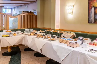 a table with food on it in a restaurant at Hotel Relais Orsingher in Fiera di Primiero
