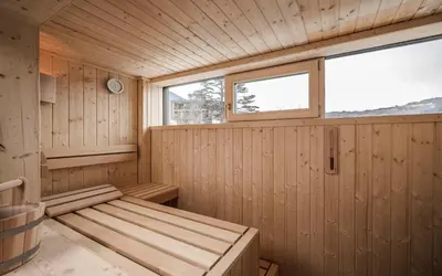 a sauna with a bench and a window at apartments55 in Bressanone