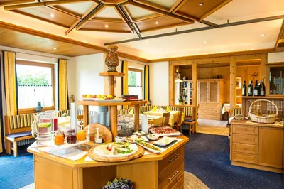a large room with a table with food on it at Hotel Pension Verdorfer in Merano