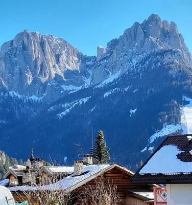 a mountain range with snow on the roofs of houses at Paragole in Pera