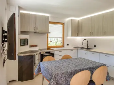 a kitchen with a table and chairs in a kitchen at Paragole in Pera