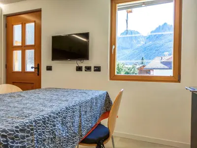 a room with a table and a tv and a window at Paragole in Pera
