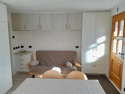 a living room with a couch and a table and chairs at Paragole in Pera