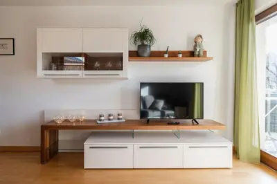 a living room with a tv and a table at FaWa Apartments 