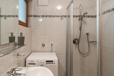 a bathroom with a shower and a toilet and a sink at FaWa Apartments 
