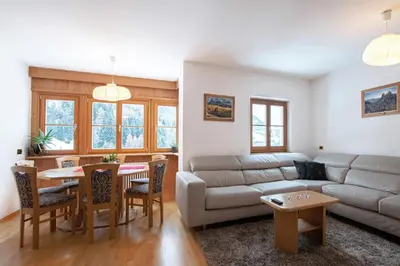 a living room with a couch and a table at Mountain Living Apartment Idylia in Ortisei