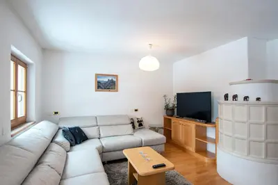 a living room with a couch and a tv at Mountain Living Apartment Idylia in Ortisei