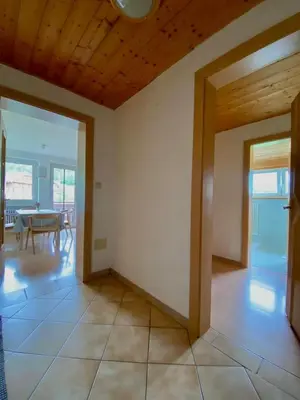 an empty room with a table and a dining room at Schönhuberhof Apartment Panoramablick in Brunico