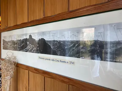 a framed picture of a mountain on a wall at Casa Loria - Appartamento con Giardino in San Martino di Castrozza