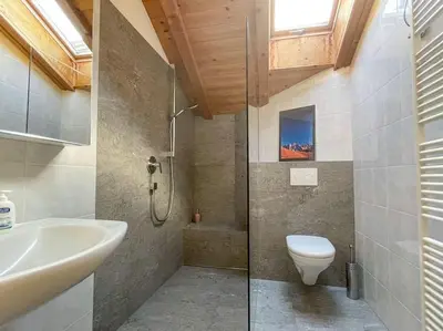 a kitchen with wooden cabinets and a sink and stove at Dolomiten View - South Tyrol in Villandro
