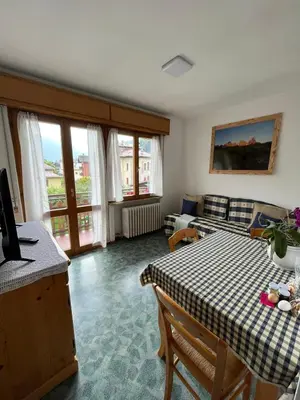 a living room with a table and a couch at Dolomitihouse AUNER in Fiera di Primiero
