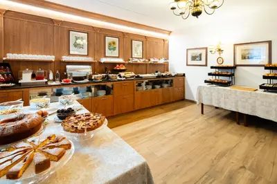 a buffet line with many different dishes of food at Hotel Menardi in Cortina dʼAmpezzo